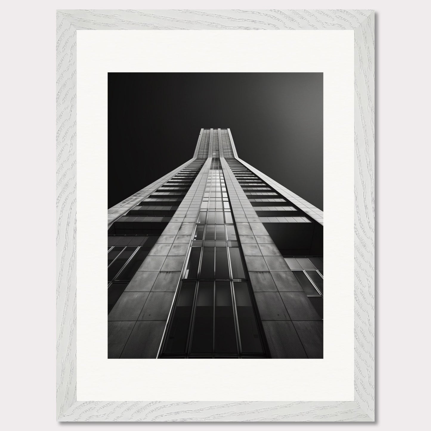 This striking black and white photograph captures the awe-inspiring perspective of looking up at a towering skyscraper. The image emphasizes the sleek lines and modern architecture, drawing the viewer's eye upwards towards the sky.