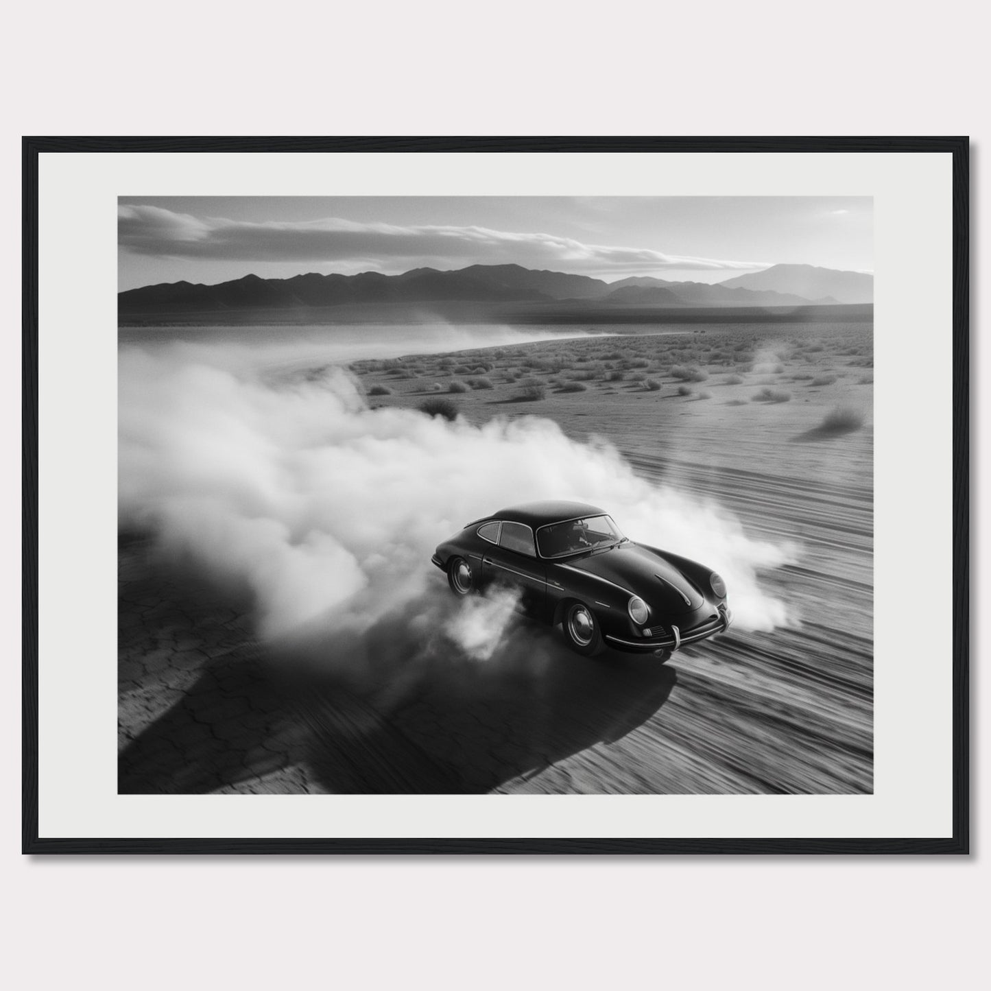 This striking black and white photograph captures a classic car speeding through a desert landscape, leaving a trail of dust in its wake. The image exudes a sense of freedom and adventure, with the distant mountains adding to the dramatic scenery.