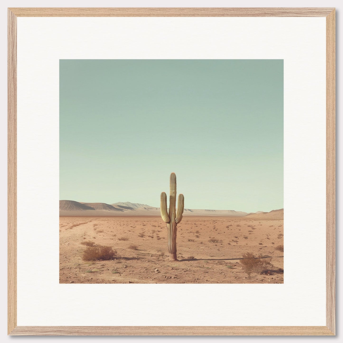 This serene photograph captures the solitary beauty of a lone cactus standing tall in a vast desert landscape. The clear blue sky stretches endlessly above, while distant mountains create a tranquil backdrop. The image is framed in a simple, elegant black border, enhancing its minimalist appeal.