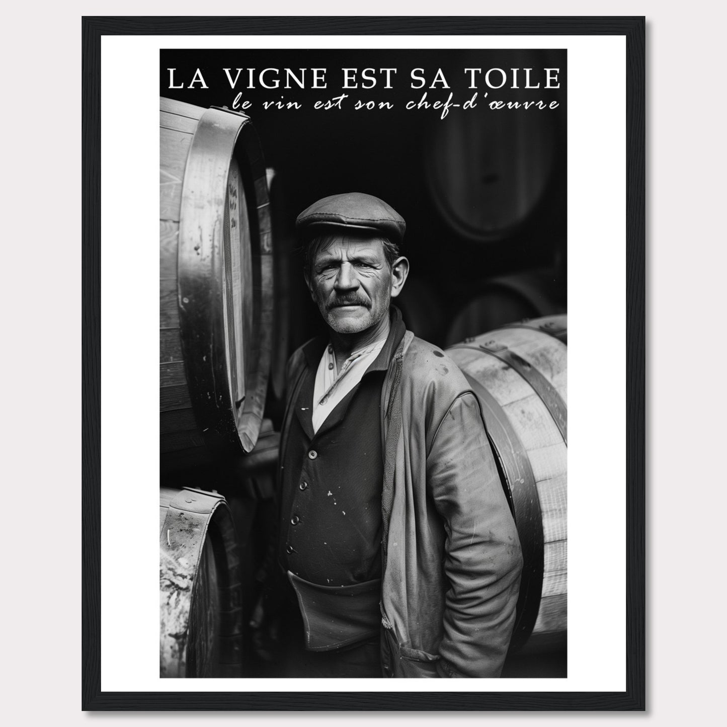 This striking black-and-white photograph captures a seasoned winemaker standing proudly among wine barrels. The text above reads, "La vigne est sa toile, le vin est son chef-d'œuvre," which translates to "The vineyard is his canvas, the wine is his masterpiece." The image exudes a sense of dedication and craftsmanship.