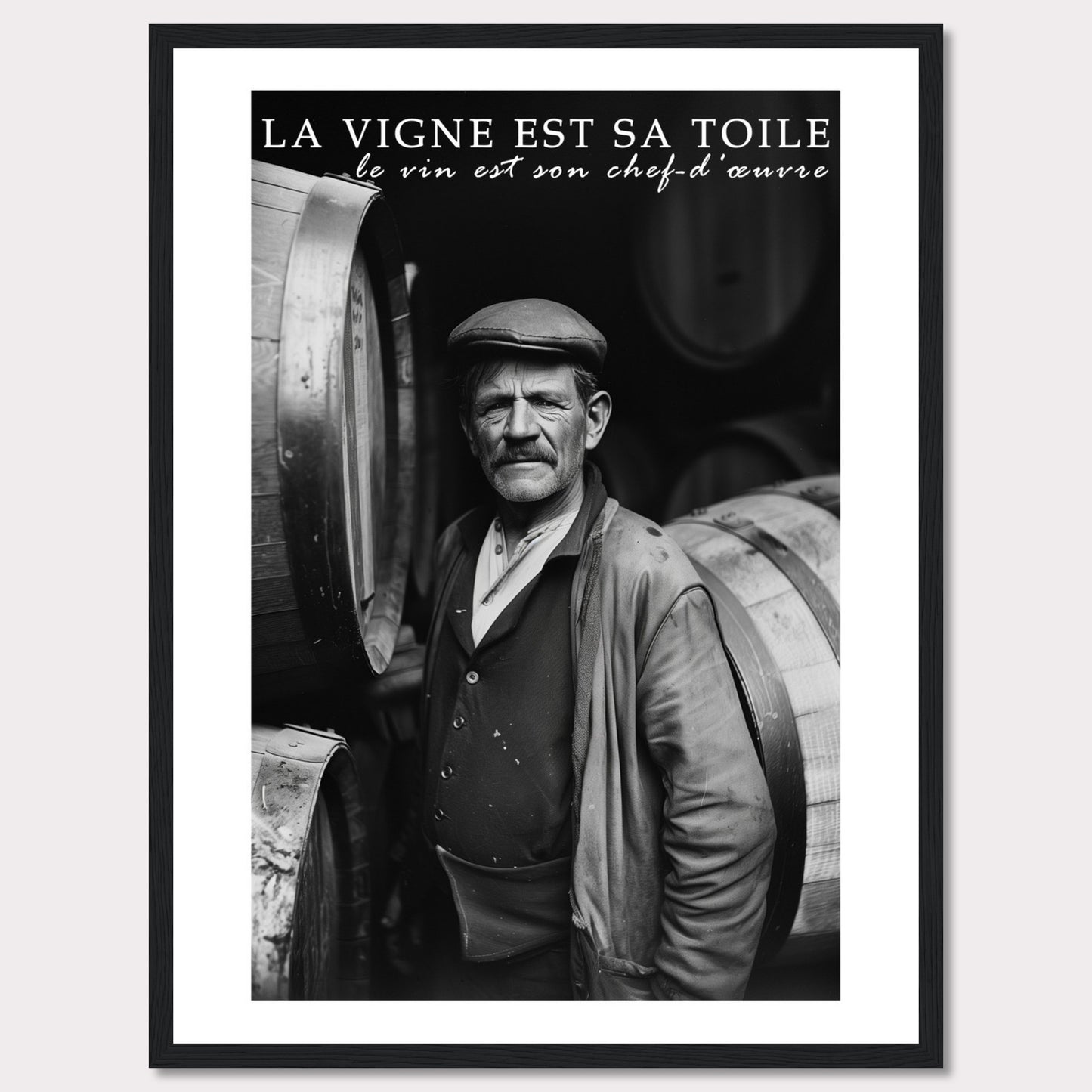 This striking black-and-white photograph captures a seasoned winemaker standing proudly among wine barrels. The text above reads, "La vigne est sa toile, le vin est son chef-d'œuvre," which translates to "The vineyard is his canvas, the wine is his masterpiece." The image exudes a sense of dedication and craftsmanship.