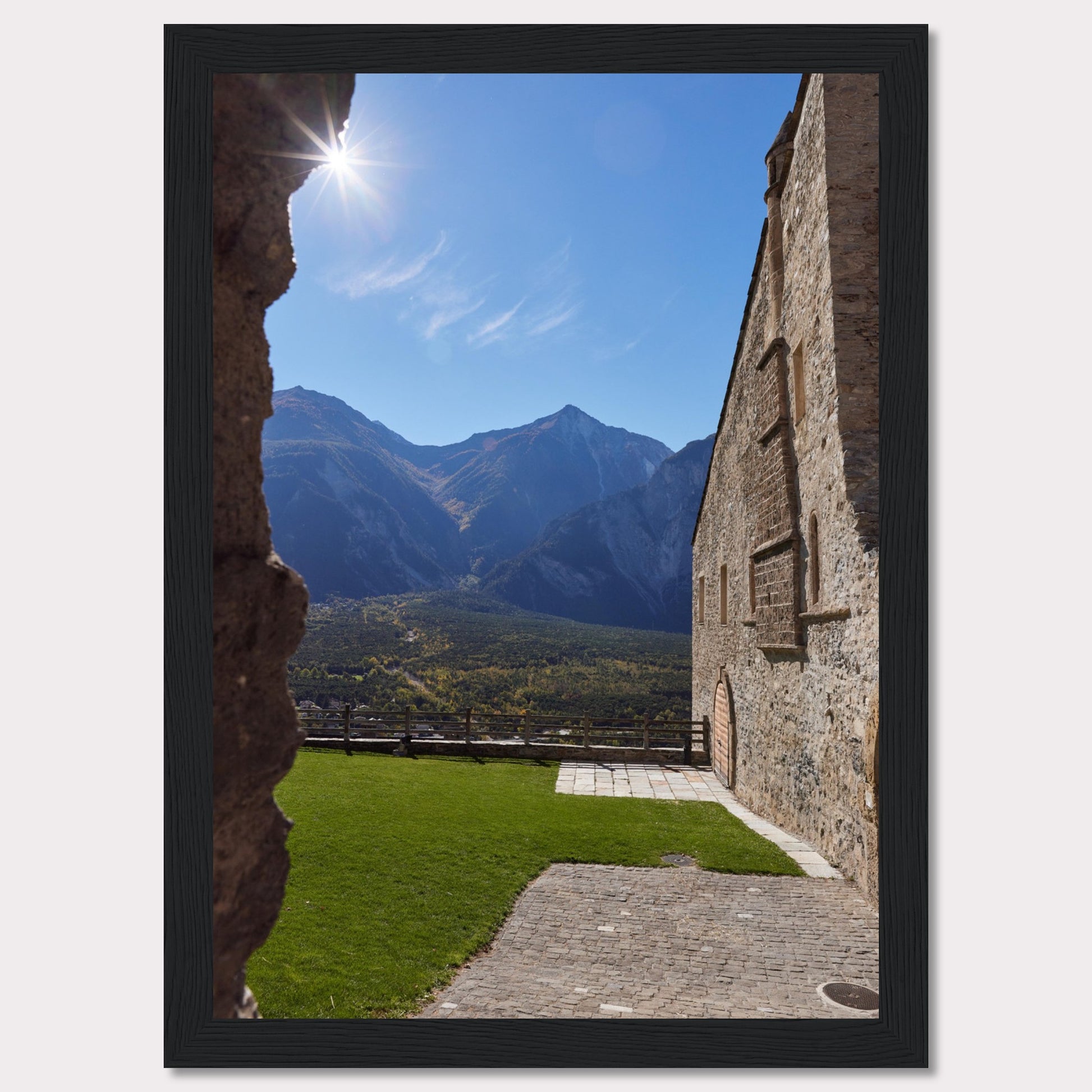 This captivating image showcases a stunning view of a mountainous landscape framed by the rustic stone walls of an ancient structure. The bright sun shines above, casting a warm glow over the scene.