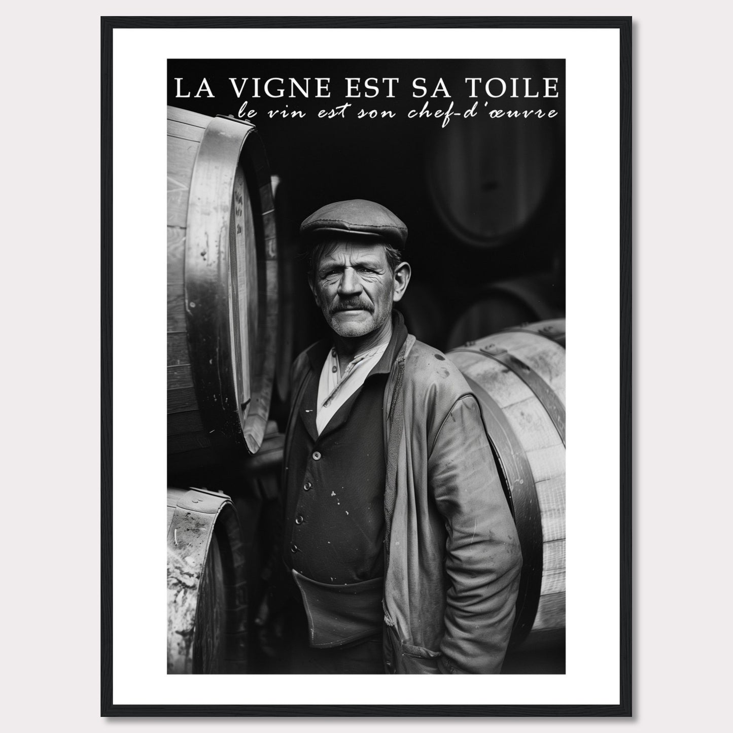 This striking black-and-white photograph captures a seasoned winemaker standing proudly among wine barrels. The text above reads, "La vigne est sa toile, le vin est son chef-d'œuvre," which translates to "The vineyard is his canvas, the wine is his masterpiece." The image exudes a sense of dedication and craftsmanship.