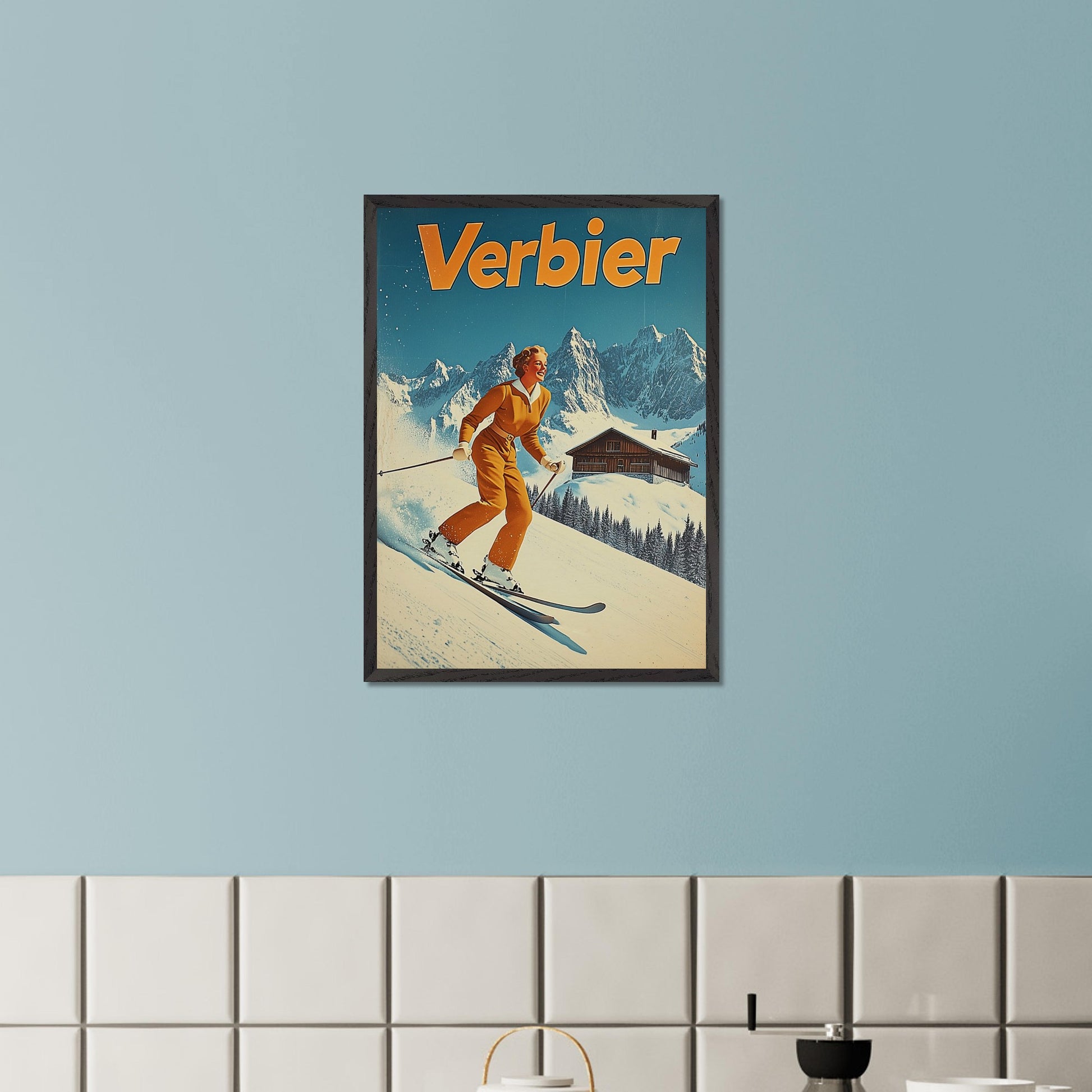 This vibrant retro poster features a cheerful skier dressed in a classic orange ski outfit, gliding down the pristine slopes of Verbier. Behind her, a picturesque alpine chalet sits amidst snow-covered peaks, with a bright blue sky completing the idyllic scene. The bold typography and clean lines enhance the nostalgic charm, inviting viewers to experience the joys of skiing in Verbier.