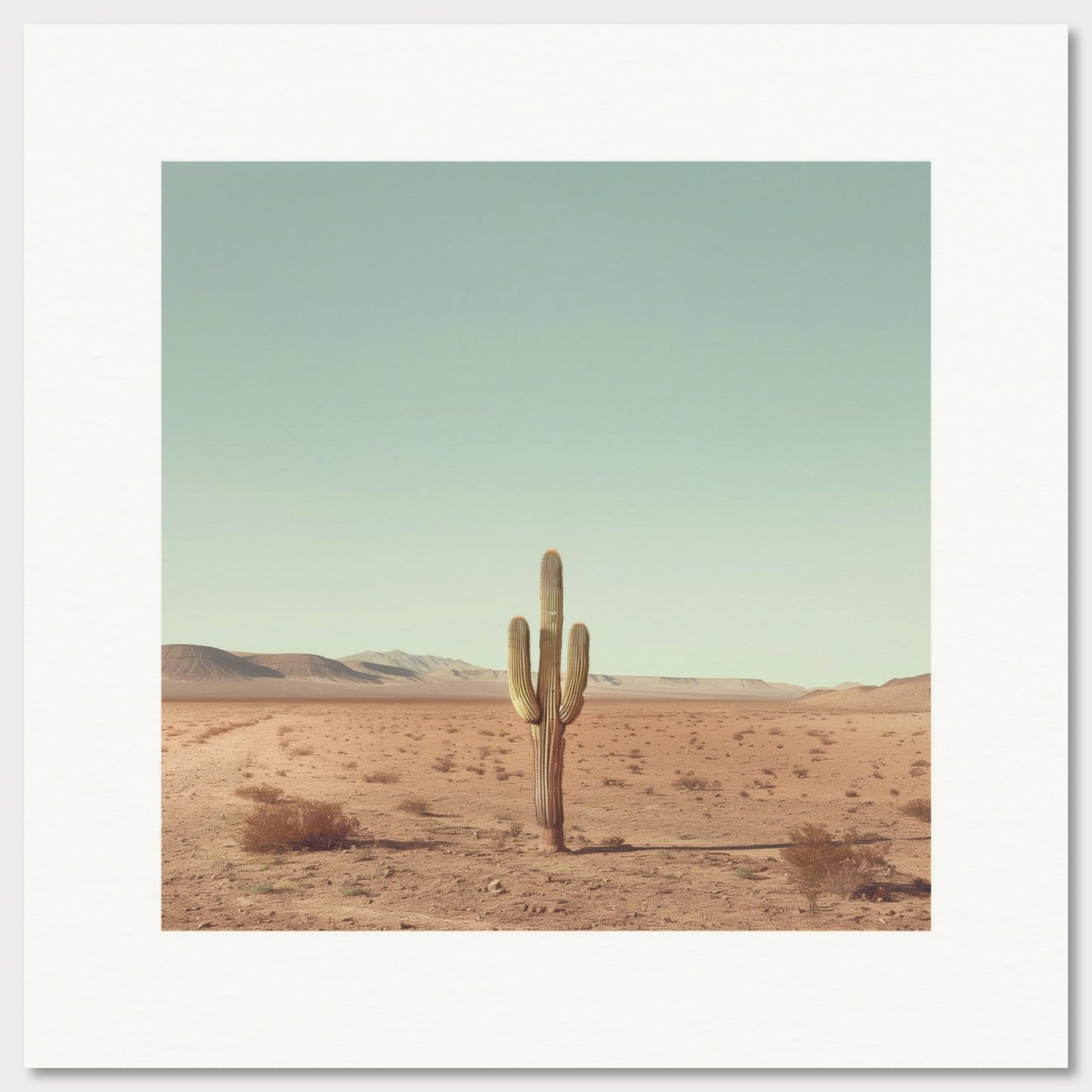 This serene photograph captures the solitary beauty of a lone cactus standing tall in a vast desert landscape. The clear blue sky stretches endlessly above, while distant mountains create a tranquil backdrop. The image is framed in a simple, elegant black border, enhancing its minimalist appeal.