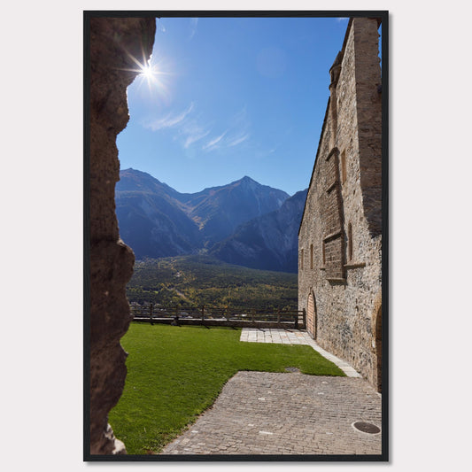 This captivating image showcases a stunning view of a mountainous landscape framed by the rustic stone walls of an ancient structure. The bright sun shines above, casting a warm glow over the scene.