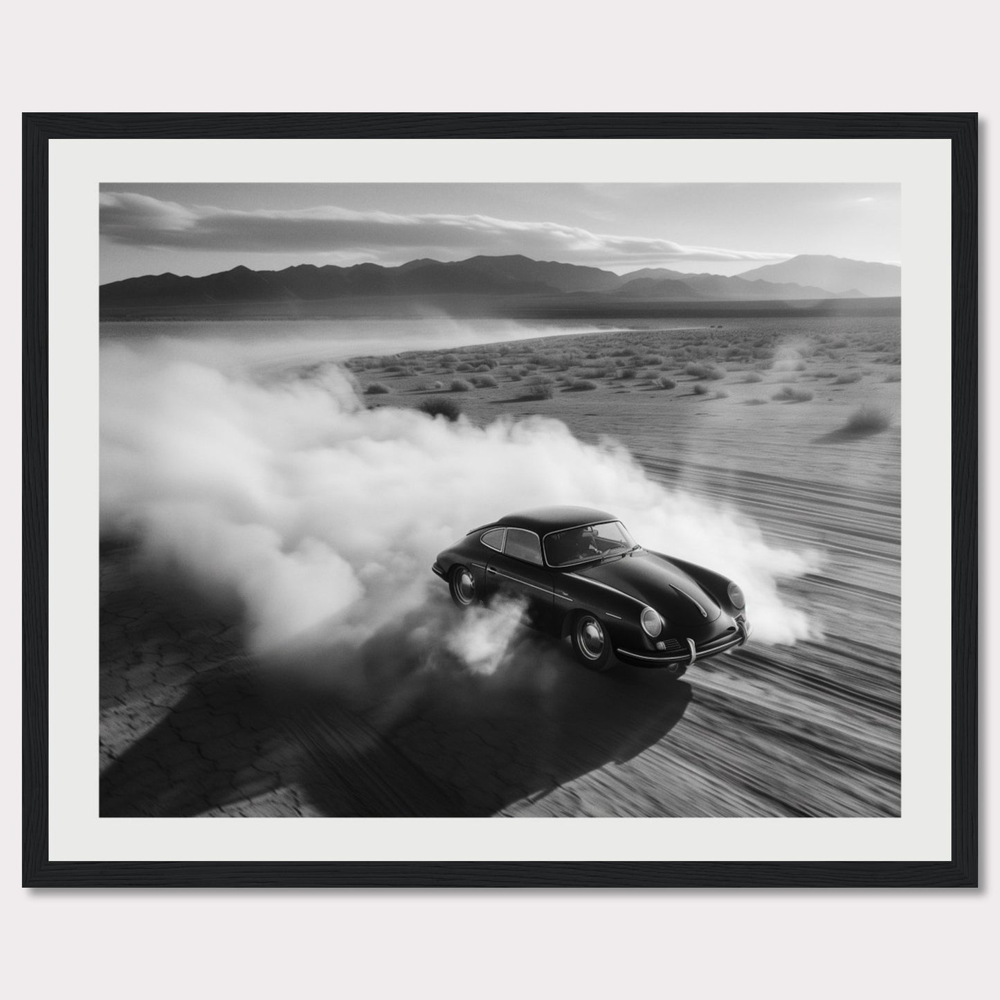 This striking black and white photograph captures a classic car speeding through a desert landscape, leaving a trail of dust in its wake. The image exudes a sense of freedom and adventure, with the distant mountains adding to the dramatic scenery.